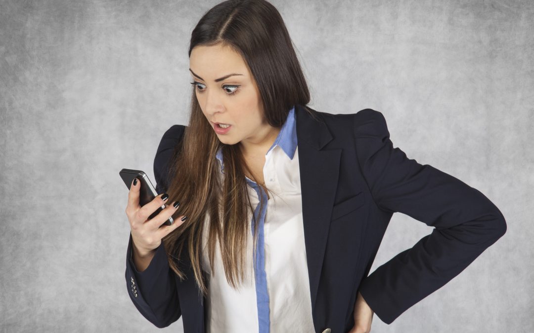 surprised business woman reading email on phone